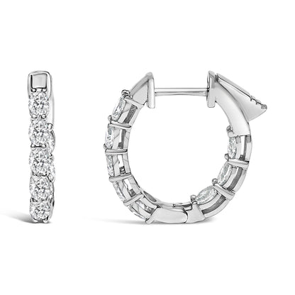 Pair of white metal hoop earrings with oval-shaped white gemstones in shared prong settings, shown from front and side angles on a white background.
