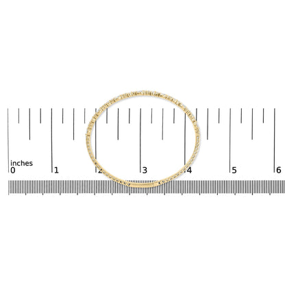 Top-down close-up view of a yellow metal bracelet with white pear and round gemstones set along its outer edge, shown on a measurement scale.