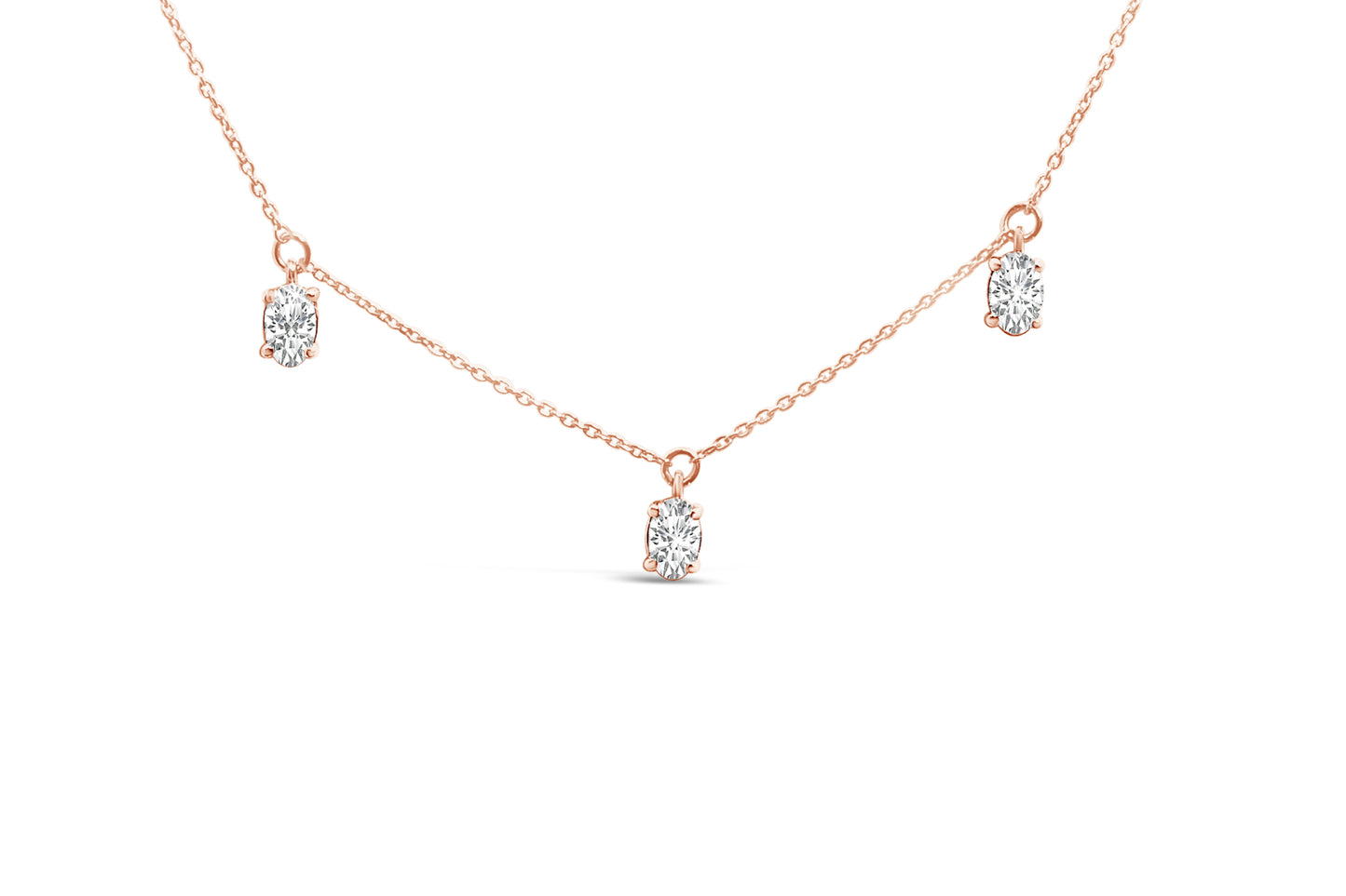 Close-up front view of a rose-colored necklace with three oval-shaped white gemstones in 4-prong settings evenly spaced along the chain.