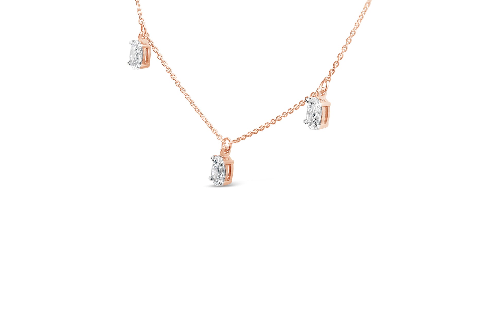 Close-up front angle of a rose-colored necklace with multiple oval-shaped white gemstones in four-prong settings.