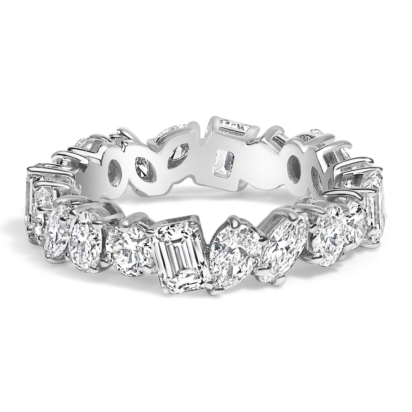 Close-up angled view of a white metal eternity ring featuring an alternating pattern of white gemstones in round, oval, marquise, pear, and emerald shapes, all set with prongs around the band.