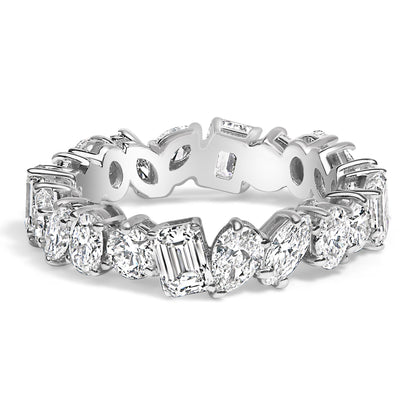 Close-up angled view of a white metal eternity ring featuring an alternating pattern of white gemstones in round, oval, marquise, pear, and emerald shapes, all set with prongs around the band.