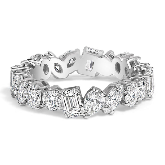 Close-up angled view of a white metal eternity ring featuring an alternating pattern of white gemstones in round, oval, marquise, pear, and emerald shapes, all set with prongs around the band.