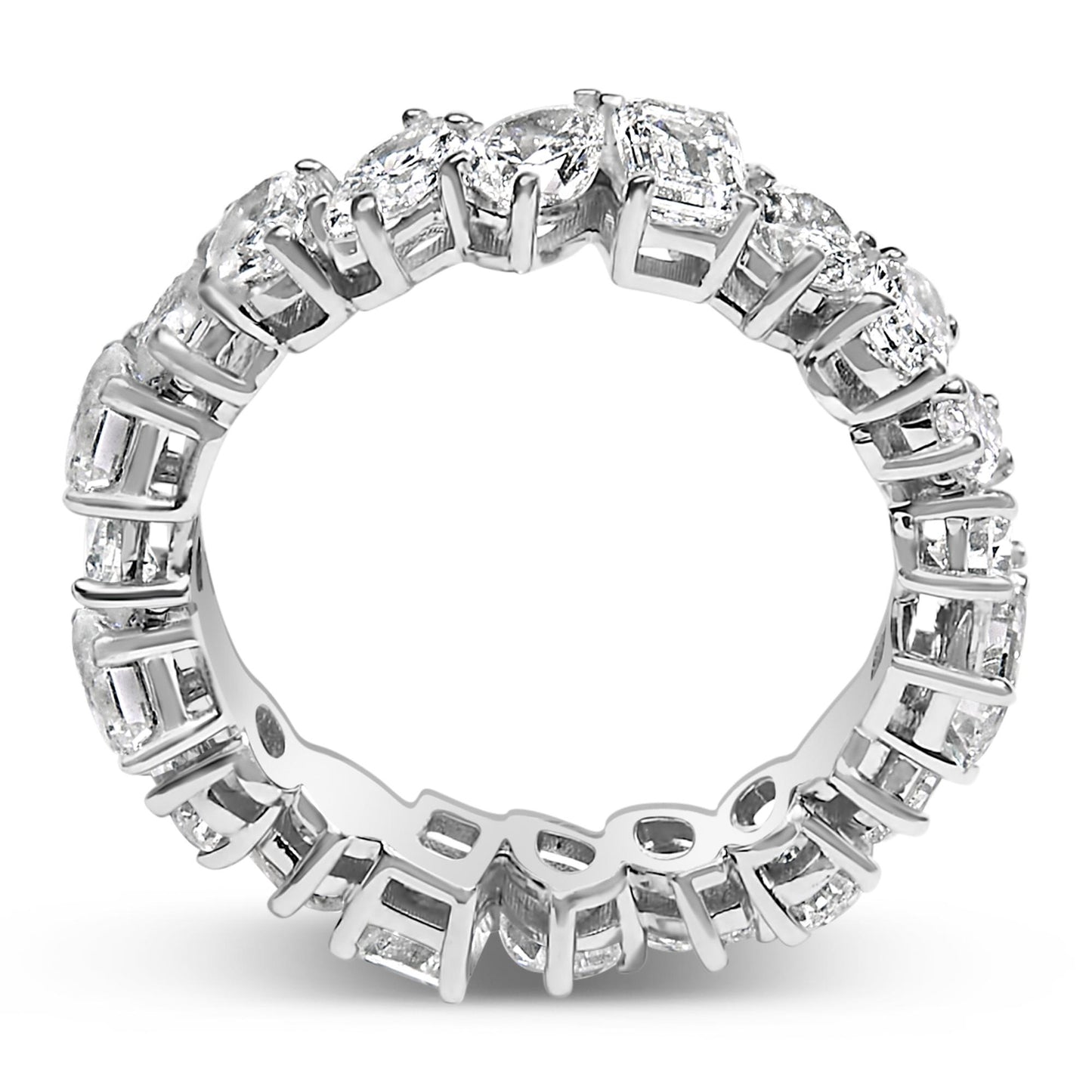 Close-up front angle of a white metal eternity ring featuring an alternating pattern of oval, pear, round, marquise, and emerald shaped white gemstones in prong settings.