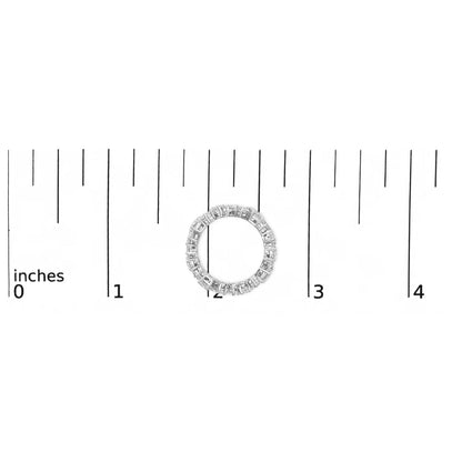 White metal ring with emerald-shaped gemstones in a continuous prong setting, shown from the top on a ruler scale.