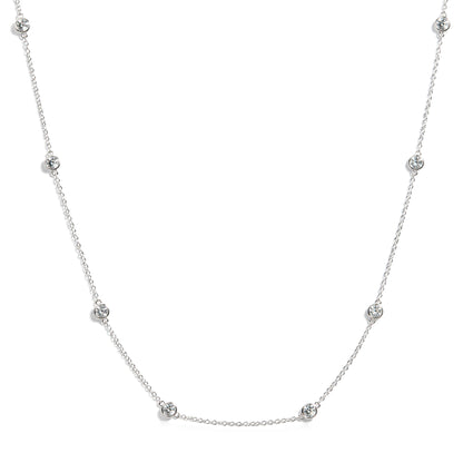 White necklace with round white gemstones in bezel settings along chain, shown on white background with front view.