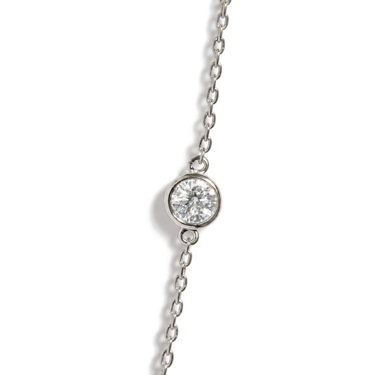 Close-up top angle view of a white metal necklace chain featuring a round white gemstone in a bezel setting.