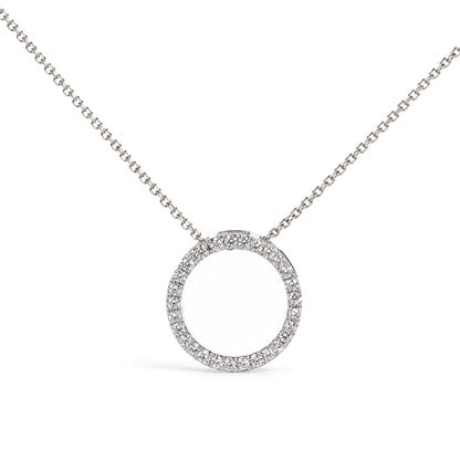 Close-up front angle of a white circular pendant necklace featuring round white gemstones in prong settings along the circle, suspended from a white metal chain.