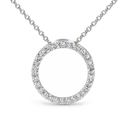 Close-up front view of a white metal necklace featuring a circular pendant encrusted with round white gemstones in a prong setting, shown on a white background.