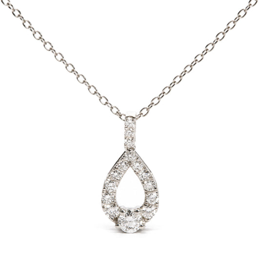 Close-up front view of a white necklace chain with a teardrop-shaped pendant encrusted with round white gemstones in prong settings, shown on a white background.
