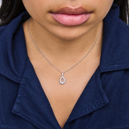 Close-up front view of a model wearing a white metal necklace with a pendant featuring multiple round white gemstones in a prong setting.