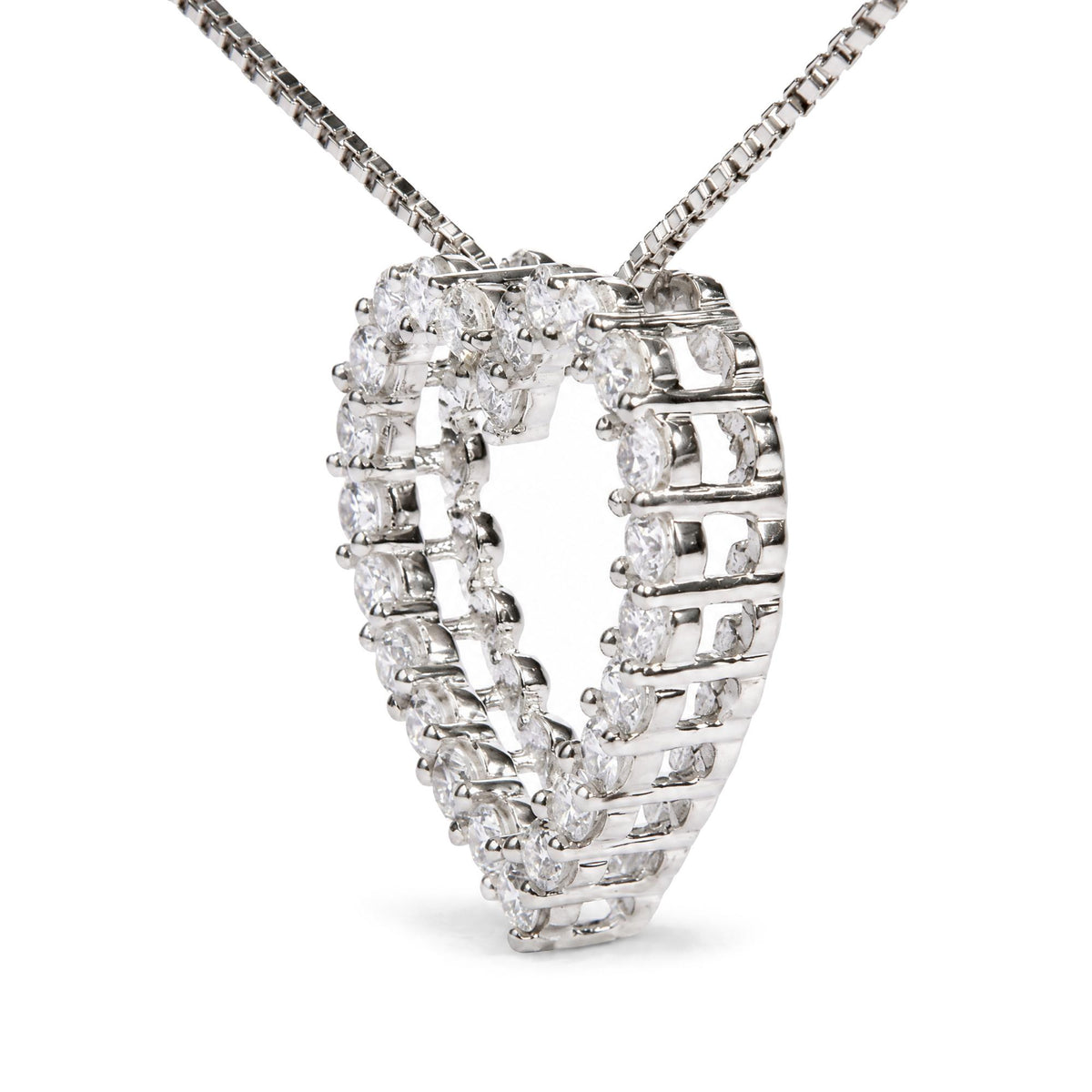 Close-up angled view of a white metal necklace with round white gemstones set in prong settings forming a heart shape, shown on a white background.