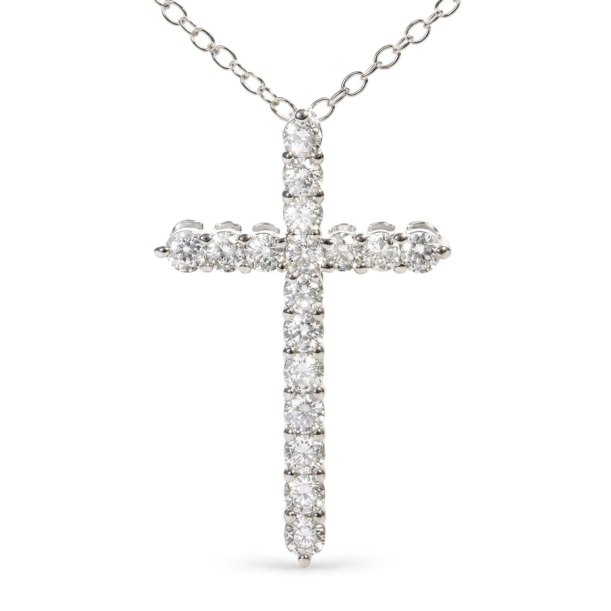 Close-up front view of a white metal cross pendant necklace adorned with round white gemstones in prong settings, suspended from a white metal chain.
