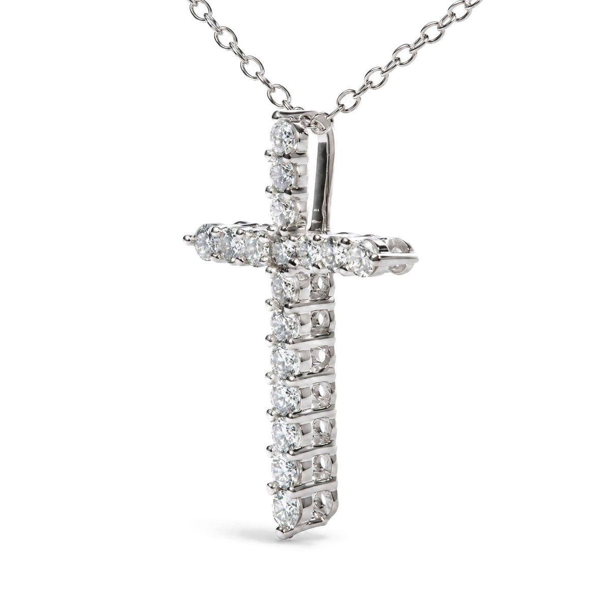 Close-up front angle of a white metal cross-shaped necklace pendant with round white gemstones in prong settings, shown on a white background.