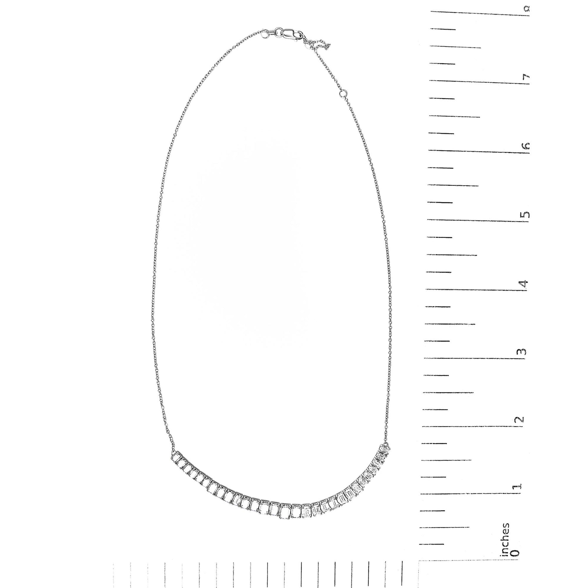 White necklace with a curved row of emerald-shaped white gemstones in 4-prong settings, shown flat on a scale, front view.