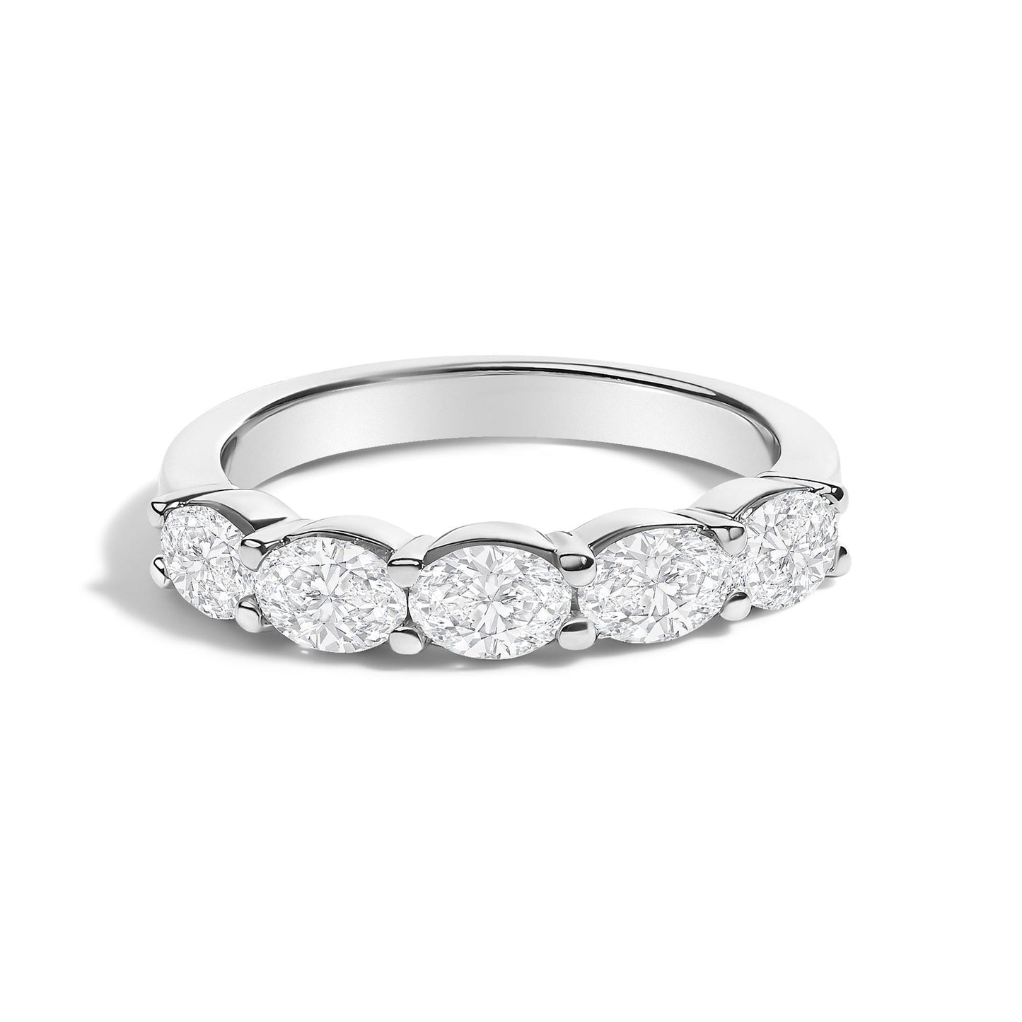 Close-up front angle of a white ring featuring five oval-shaped white gemstones set in a shared prong setting.