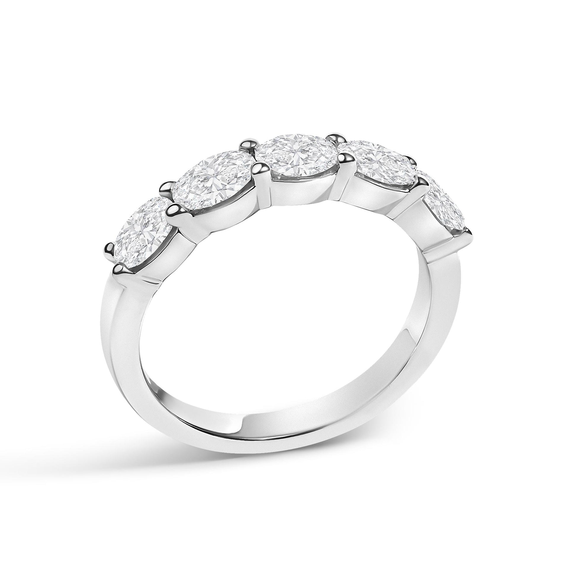 White metal ring with five oval-shaped white gemstones set in a shared prong setting, shown at a slight angle against a white background.