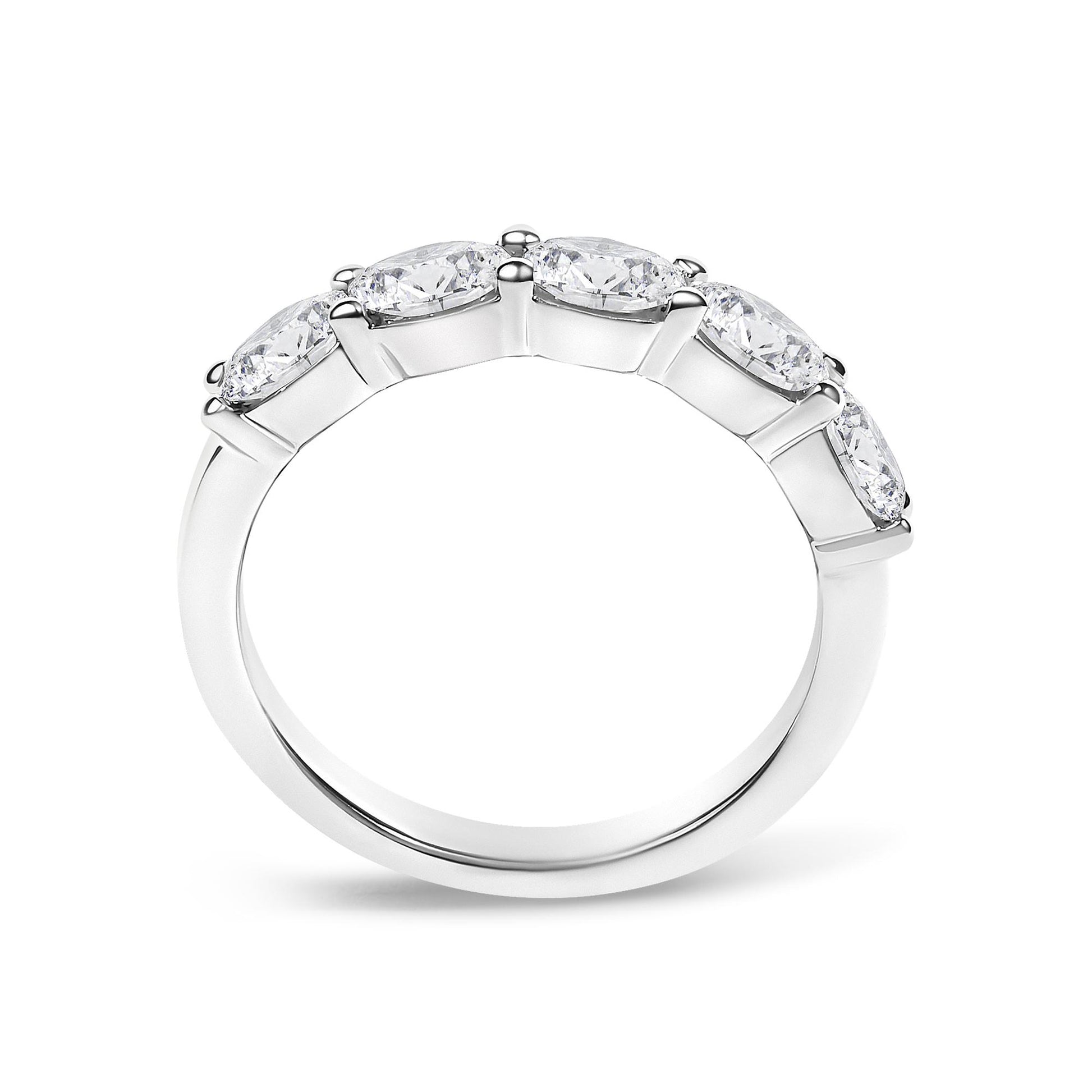White metal ring with five oval-shaped white gemstones in a shared prong setting, shown in a close-up side angle.