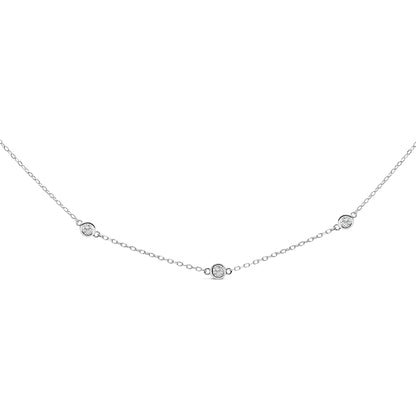 Close-up front view of a white metal necklace with round white gemstones in bezel settings evenly spaced along a delicate chain.