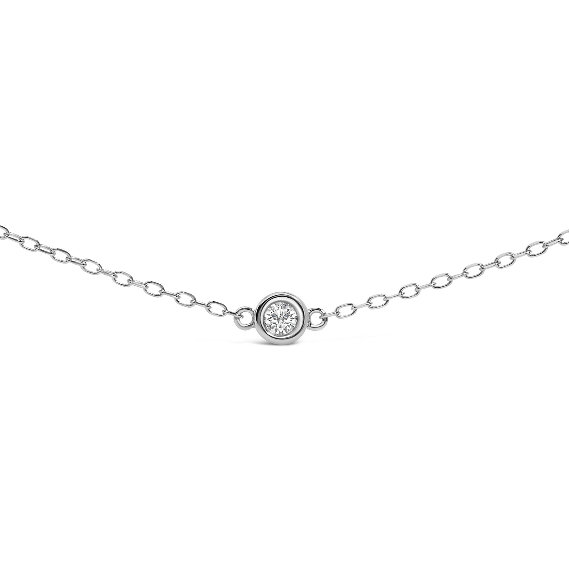 Front view of a white metal necklace with a round white gemstone in a bezel setting at the center.