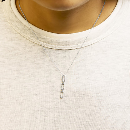White metal necklace with three elongated rectangular links, each set with round white gemstones in prong settings, shown worn on a model from the front.