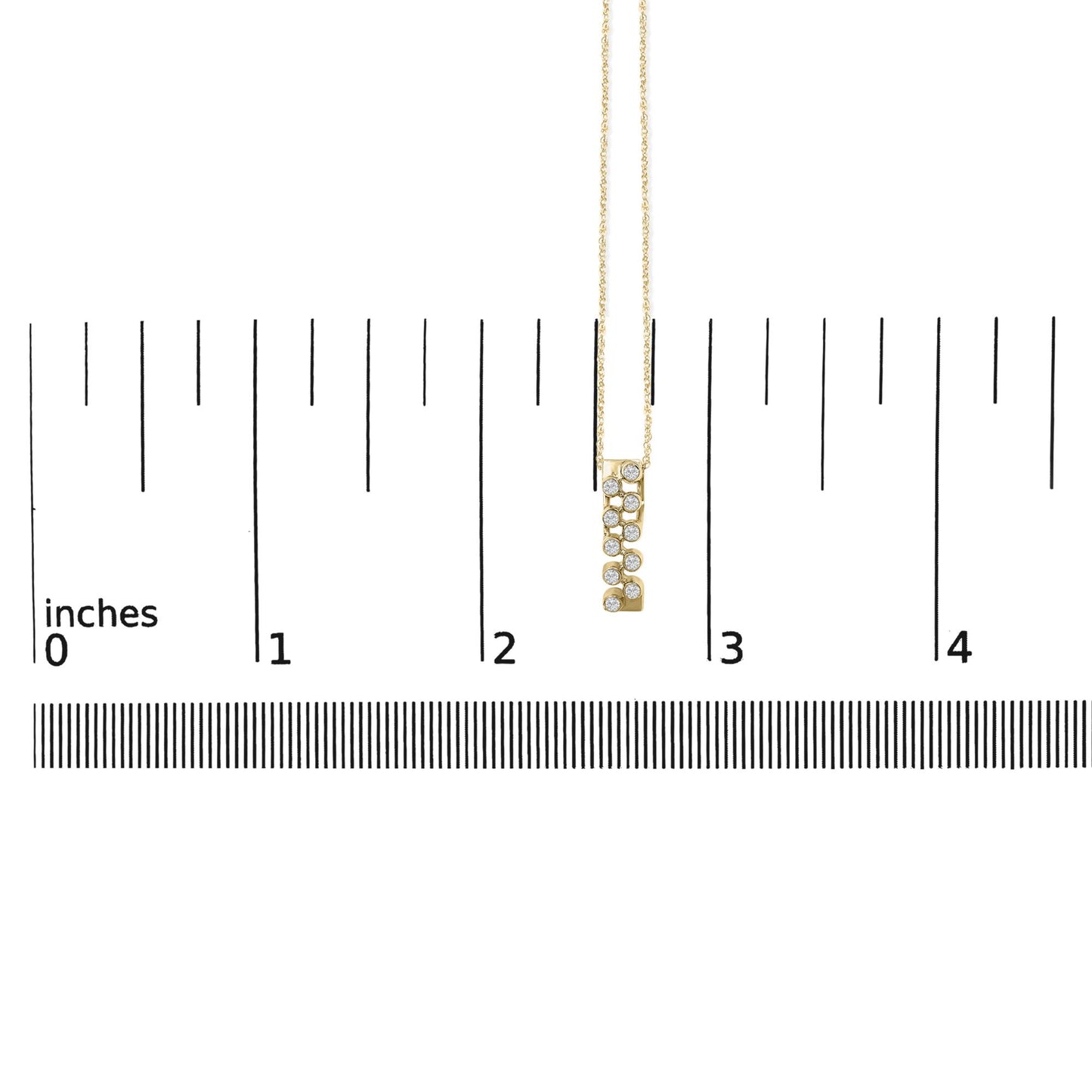 Yellow necklace with a vertical rectangular pendant featuring small round white gemstones in bezel settings, shown hanging on a ruler scale and photographed from the front.