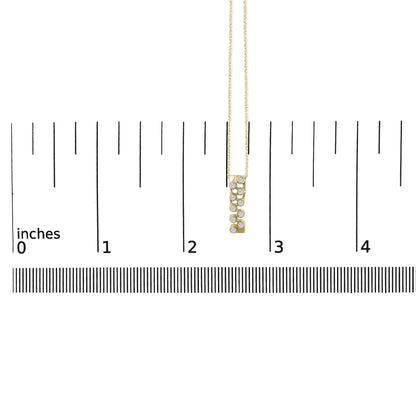 Yellow necklace with a vertical rectangular pendant featuring small round white gemstones in bezel settings, shown hanging on a ruler scale and photographed from the front.