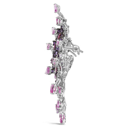 Side view of a white brooch featuring pink pear-shaped gemstones, purple round pave-set gemstones, red pear-shaped gemstones, and white round pave-set gemstones.