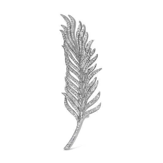 White metal brooch designed as a stylized feather with pave white gemstones, shown in a front angled view.