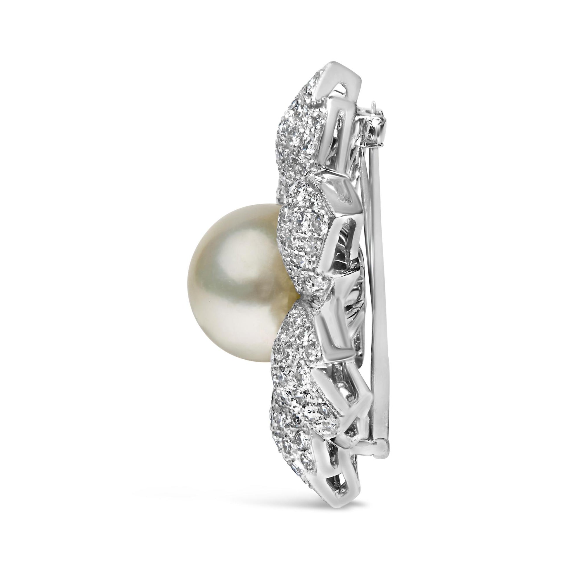 Side view of a white metal brooch with a large round pearl center and surrounding pave-set white round gemstones.