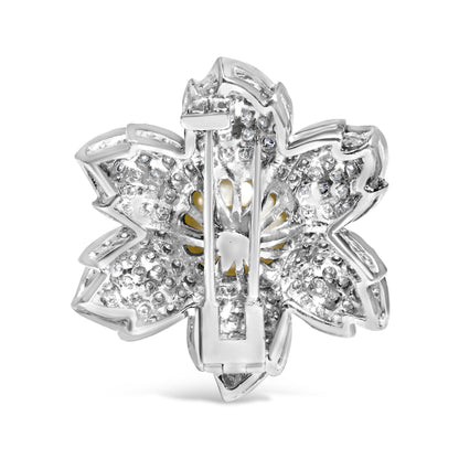 Back view of a white metal flower-shaped brooch with round pave-set white gemstones, shot from a straight-on angle.