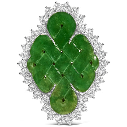 Front-facing white metal brooch with a green gemstone centerpiece in a fantasy shape surrounded by round white gemstones in prong settings.