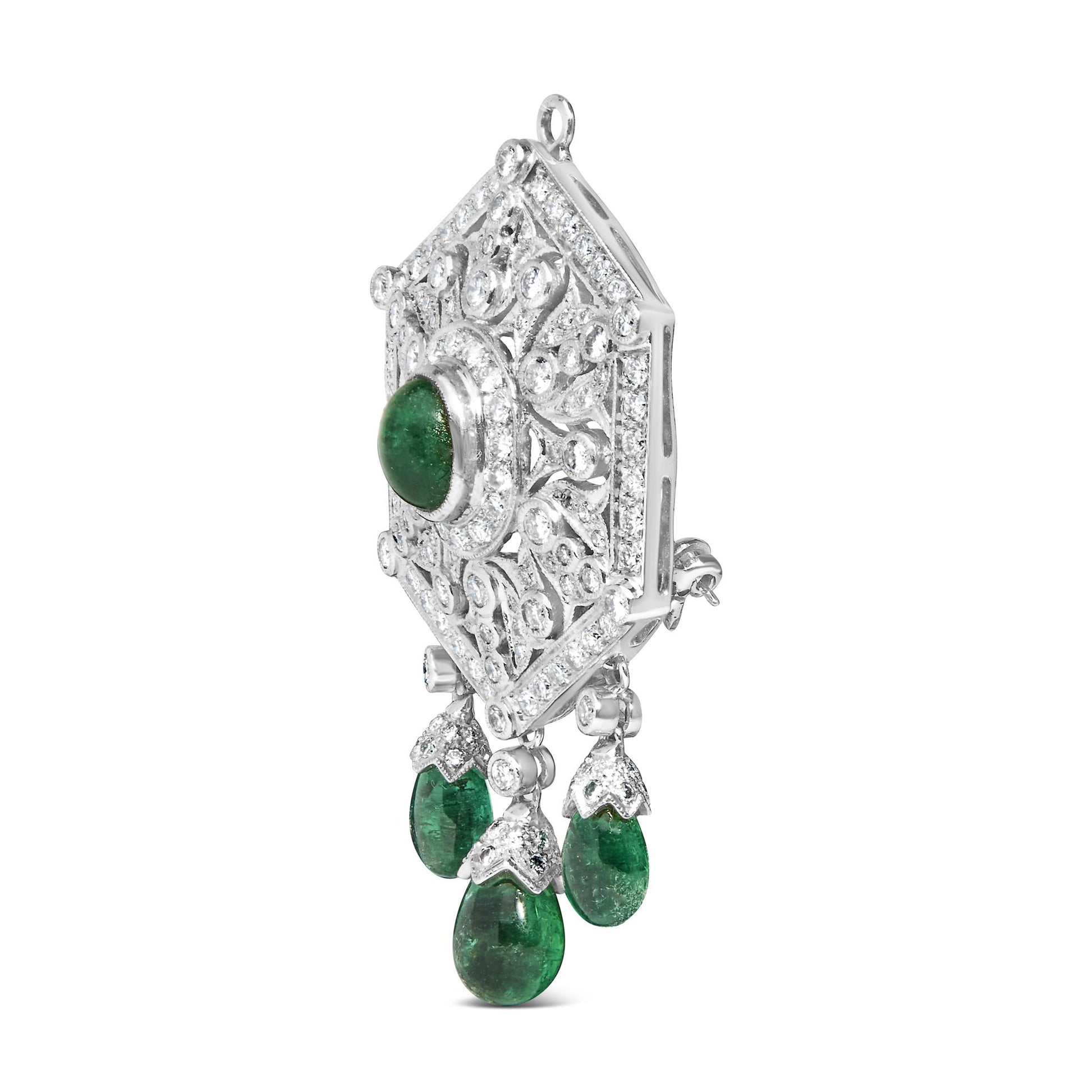 Side view of a white metal brooch with a large green oval gemstone in the center surrounded by white round gemstones in pave setting, accented with three dangling green teardrop-shaped gemstones and additional white round and marquise-shaped gemstones.