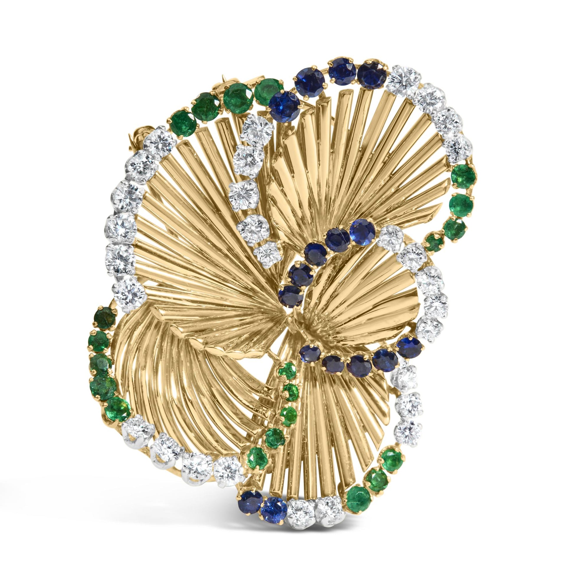 Yellow metal brooch with a swirling leaf design, accented with round white gemstones, blue gemstones, and green gemstones, shown at a slight front angle.