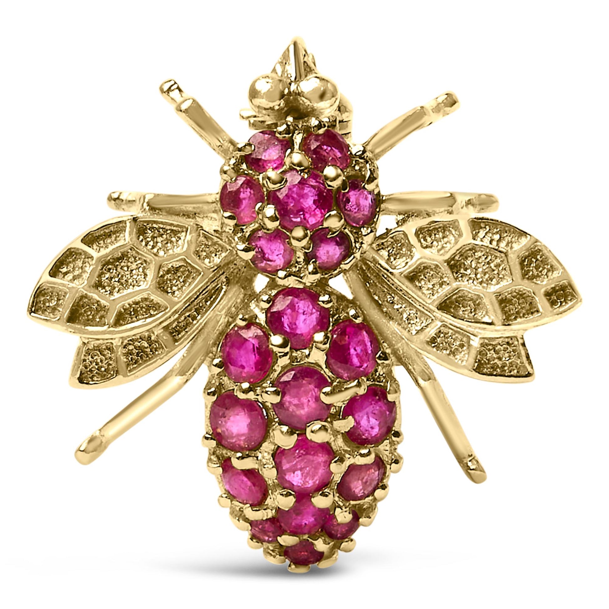 Close-up front view of a yellow metal bee-shaped brooch adorned with multiple round red gemstones on its body and head, with textured wings.
