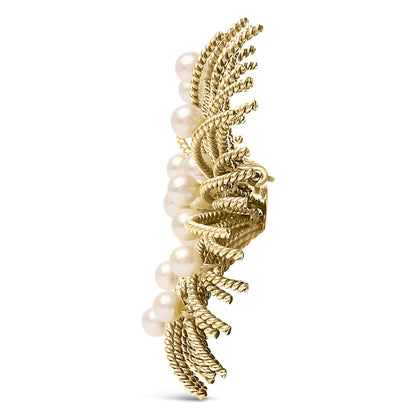 Side angle view of a yellow brooch featuring twisted rope-like details with multiple white pearl-like gemstones.