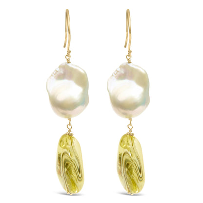 Front view of yellow metal earrings with irregular white and yellow gemstones in drilled settings.