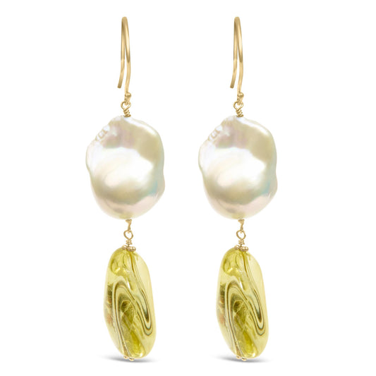 Front view of yellow metal earrings with irregular white and yellow gemstones in drilled settings.