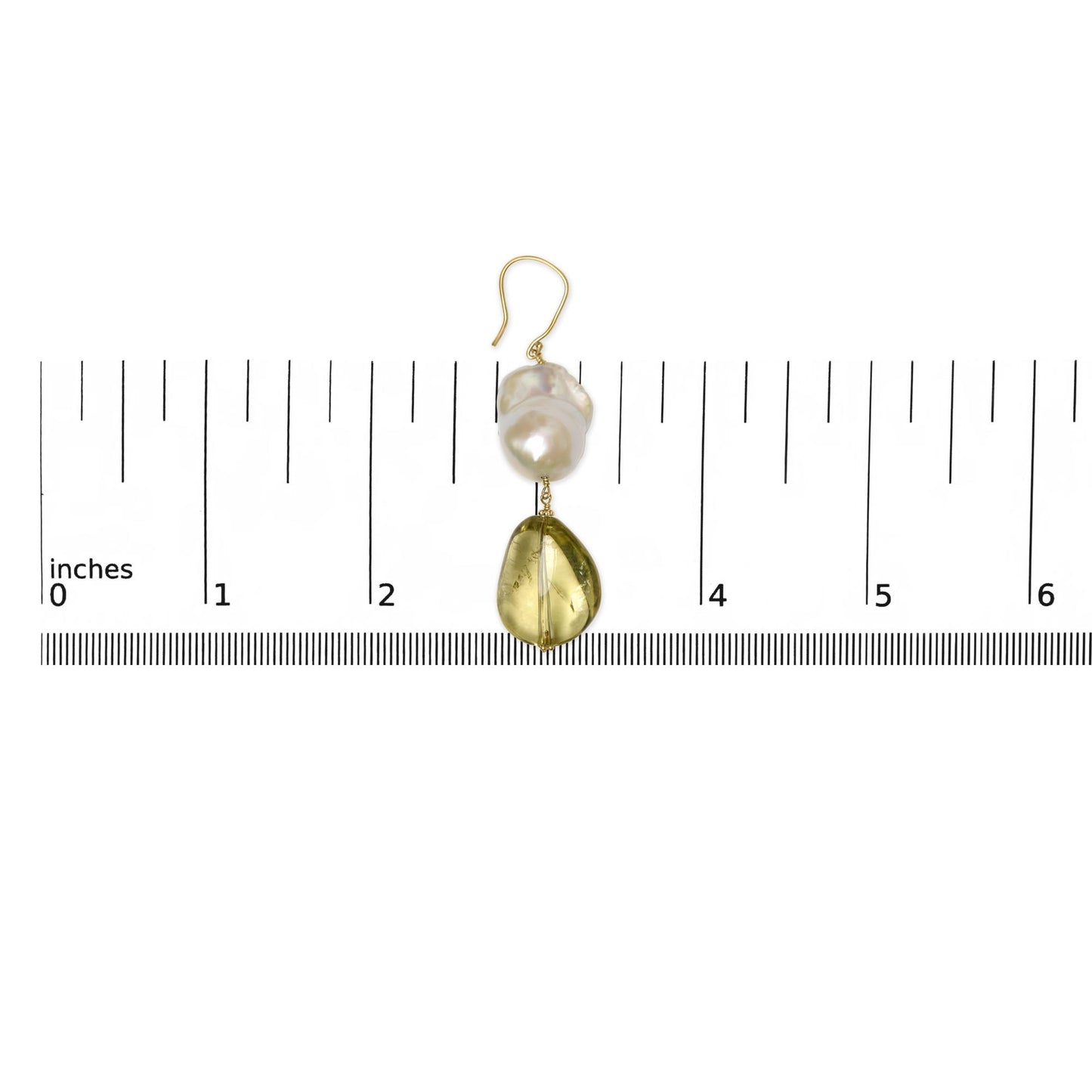 Single yellow metal earring with irregular yellow gemstone and baroque white gemstone, shown on a ruler for size reference, top-down view.