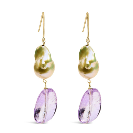 Front view of yellow metal dangle earrings with irregularly shaped top pieces and purple drilled gemstone drops.