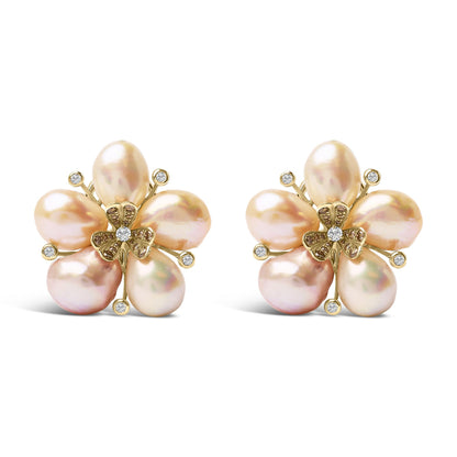 Close-up front view of a pair of rose-colored metal earrings shaped like flowers with five petal-like elements that have a soft pink sheen, accented by small round white gemstones at petal tips and a central cluster of round white and champagne-colored gemstones in various prong and pave settings.