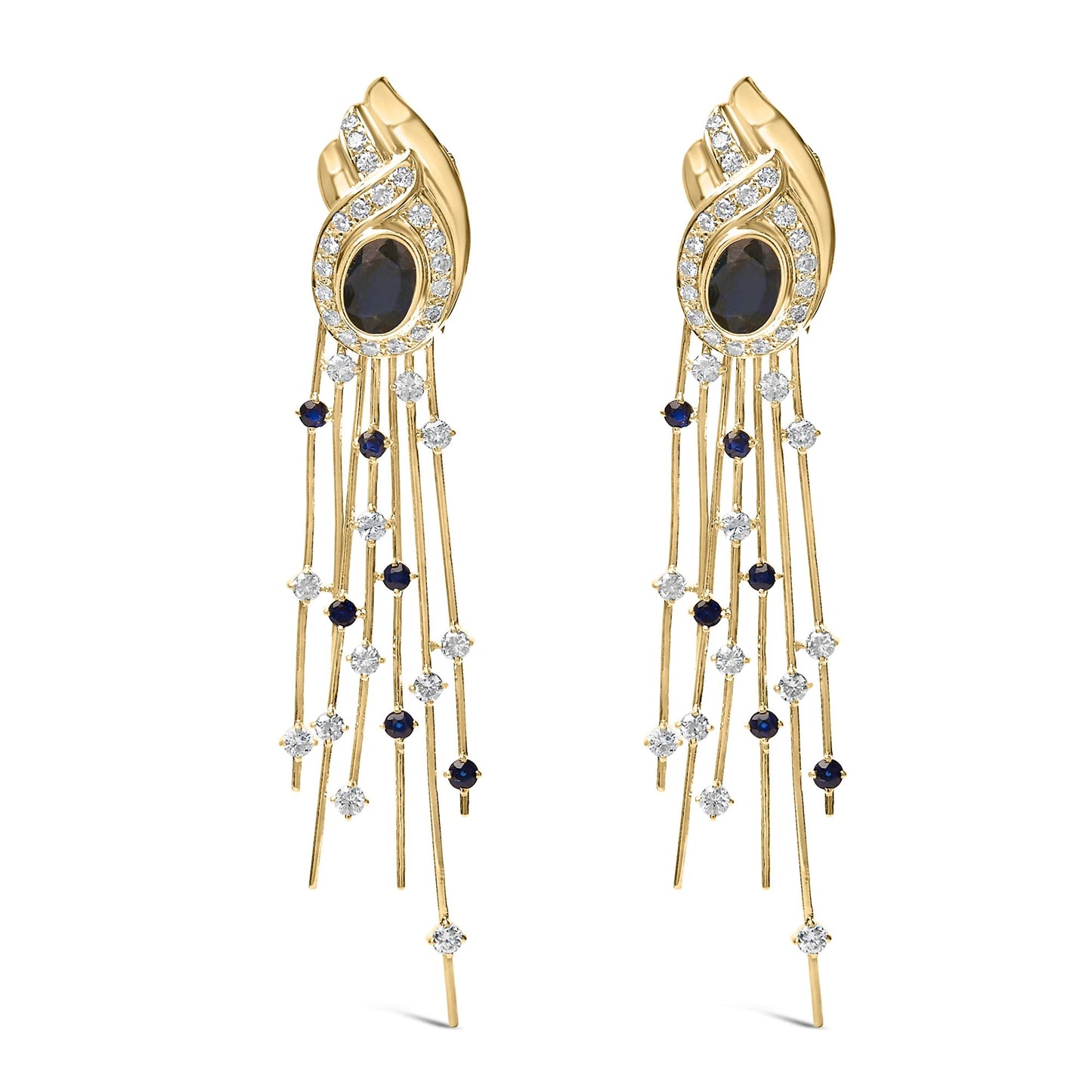 Pair of yellow metal earrings shown from the front, featuring an oval blue gemstone in a bezel setting surrounded by a swirl of white gemstones in a pave setting, with multiple thin strands dangling below adorned with round blue and white gemstones in prong settings.