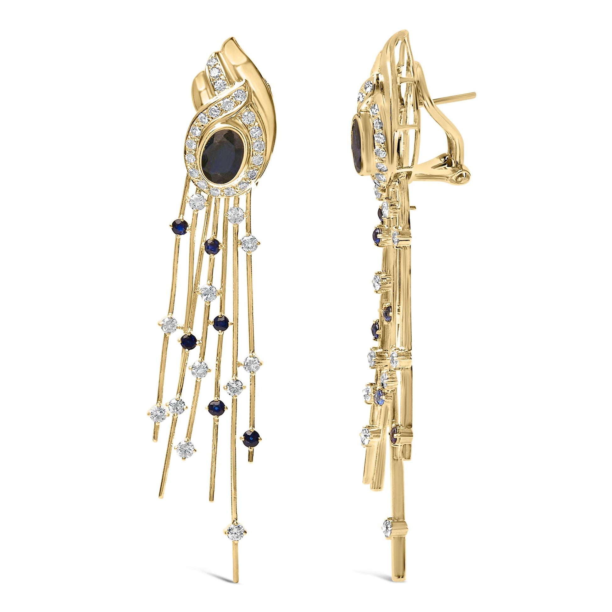 Front and side views of a pair of yellow metal drop earrings featuring an oval blue gemstone in a bezel setting surrounded by white round gemstones in a prong setting, with multiple thin dangling strands accented with alternating blue and white round gemstones.