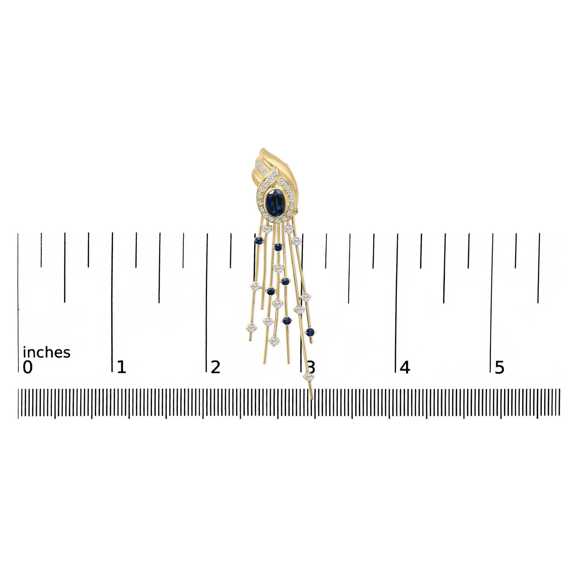 Yellow metal earring with an oval blue gemstone surrounded by white gemstones, featuring multiple dangling strands with alternating blue and white gemstones, shown on a scale from a top front angle.