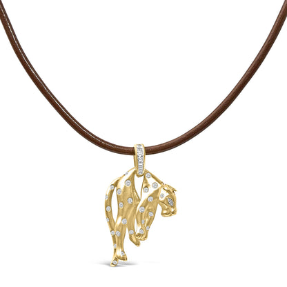 Front-facing shot of a yellow metal necklace pendant shaped like a leopard with scattered round white gemstones and a white baguette gemstone set bail, displayed on a brown cord.