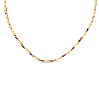 Front-facing close-up of a yellow and white metal necklace featuring alternating oval-shaped red gemstones and round white gemstones set in 4-prong settings along the chain.