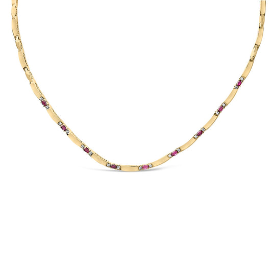 Front-facing close-up of a yellow and white metal necklace featuring alternating oval-shaped red gemstones and round white gemstones set in 4-prong settings along the chain.