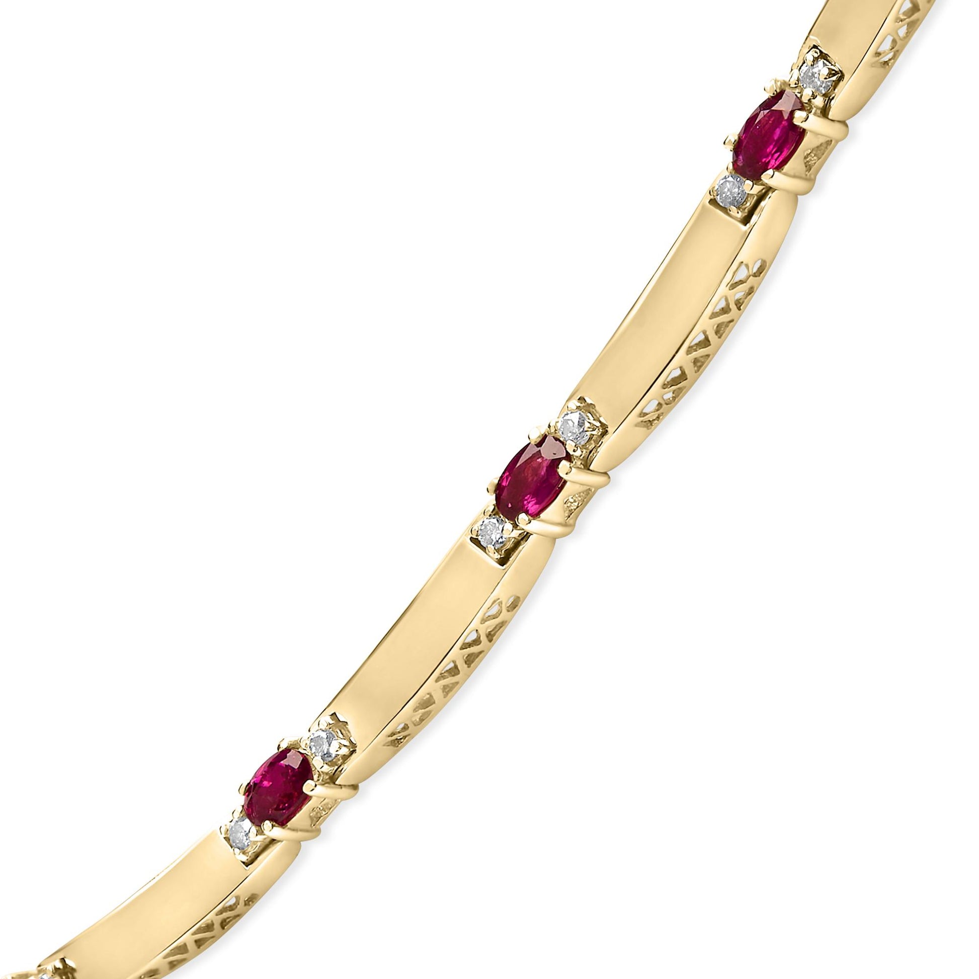 Close-up angled shot of a yellow and white metal necklace with alternating oval red gemstones and round white gemstones in 4-prong settings.