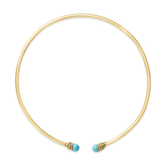 Top-down angled view of an open circular yellow metal necklace with round blue gemstone accents at each end.