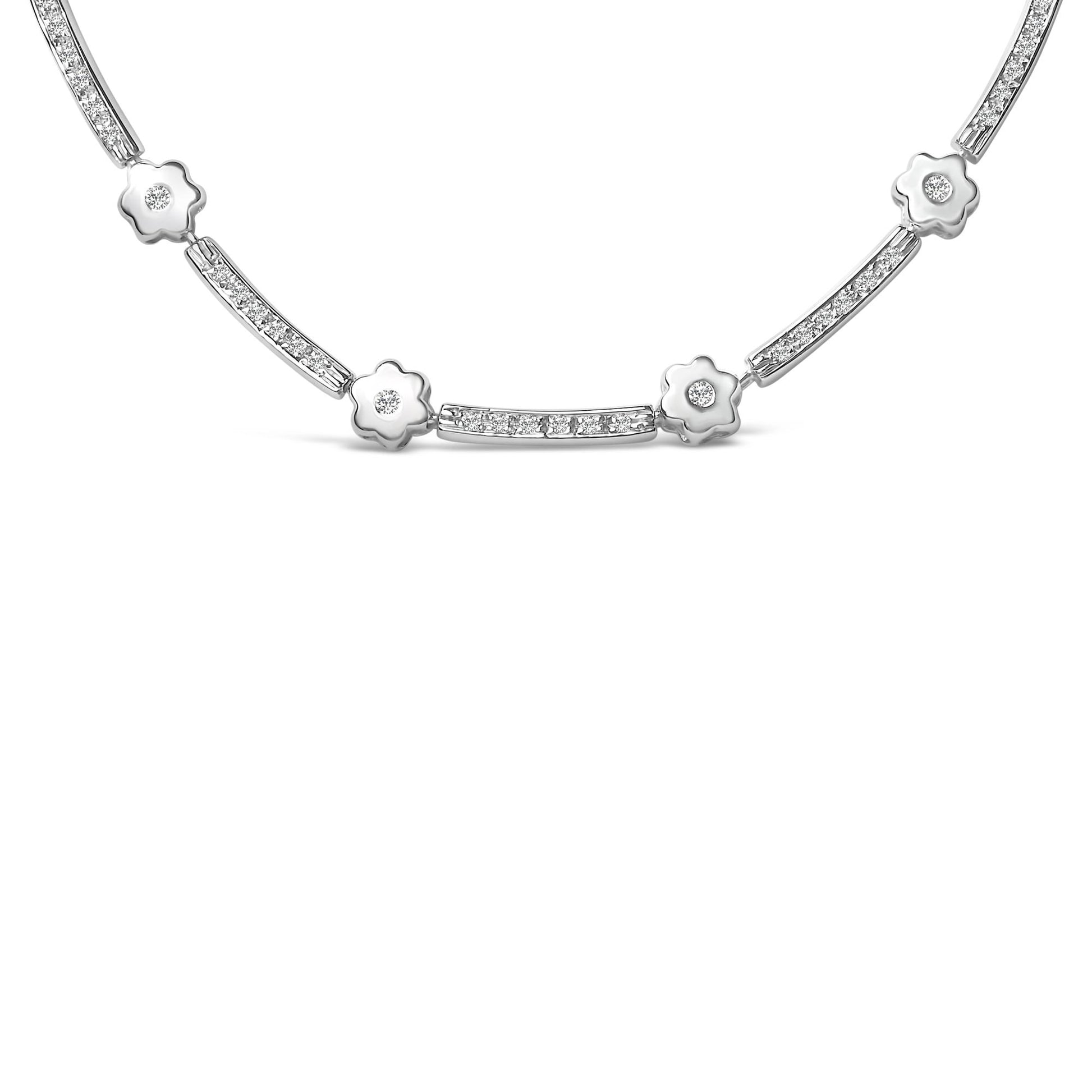 Close-up front view of a white metal necklace featuring alternating flower-shaped elements and rectangular bars, each set with round white gemstones in bezel settings.